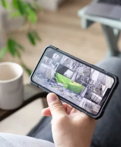 Person looking at multiple video feeds on their mobile phone